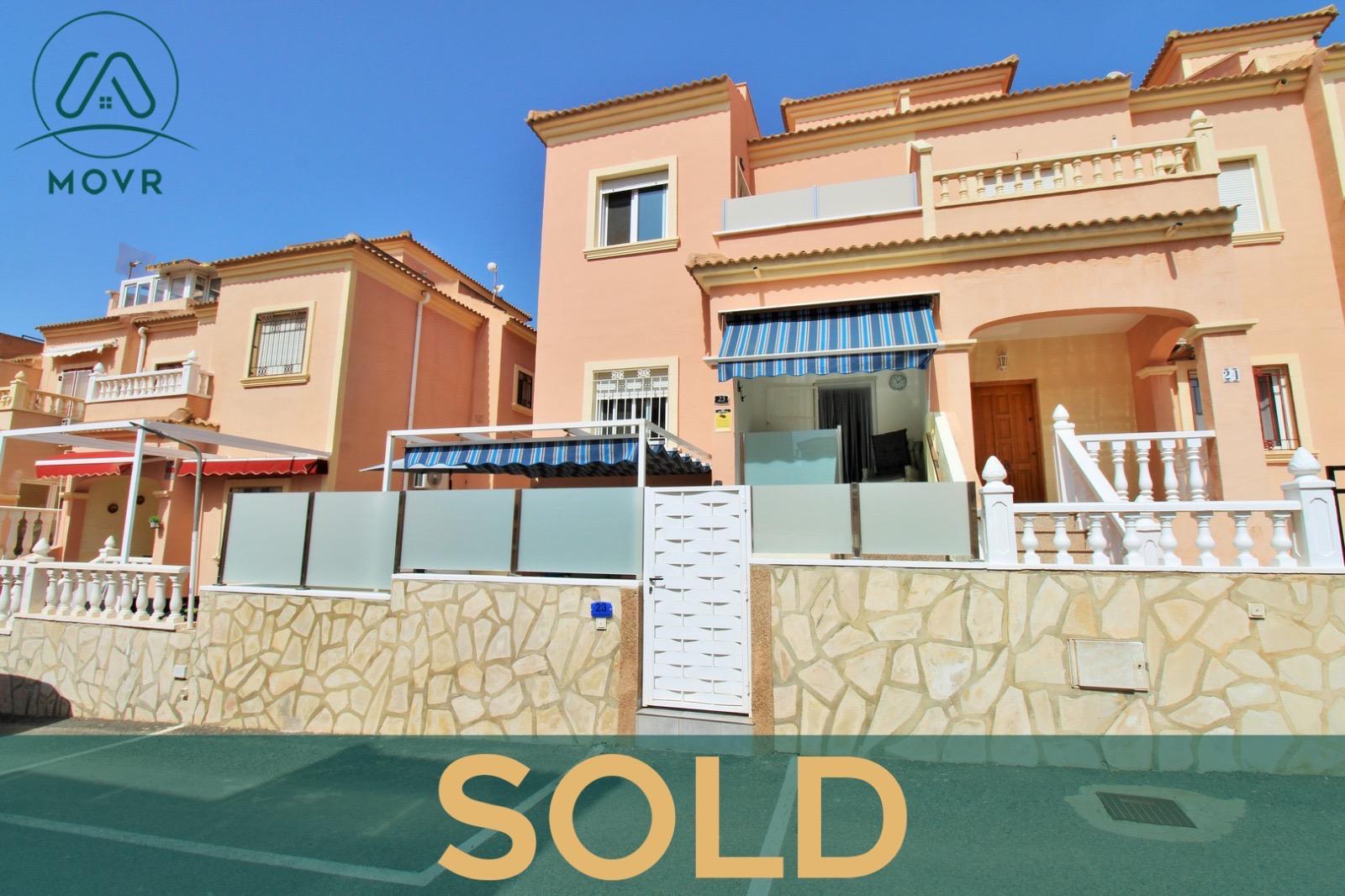 Terracotta townhouse with a gated front terrace previously sold by MOVR in Orihuela Costa