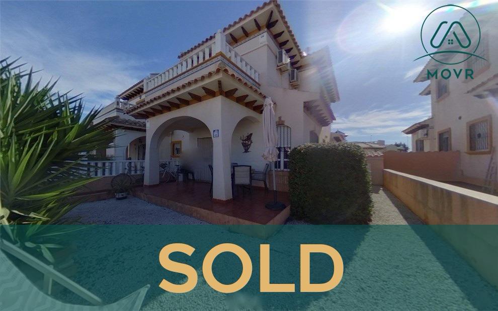 Villa with an arched covered porch and gravel garden previously sold by MOVR in Orihuela Costa