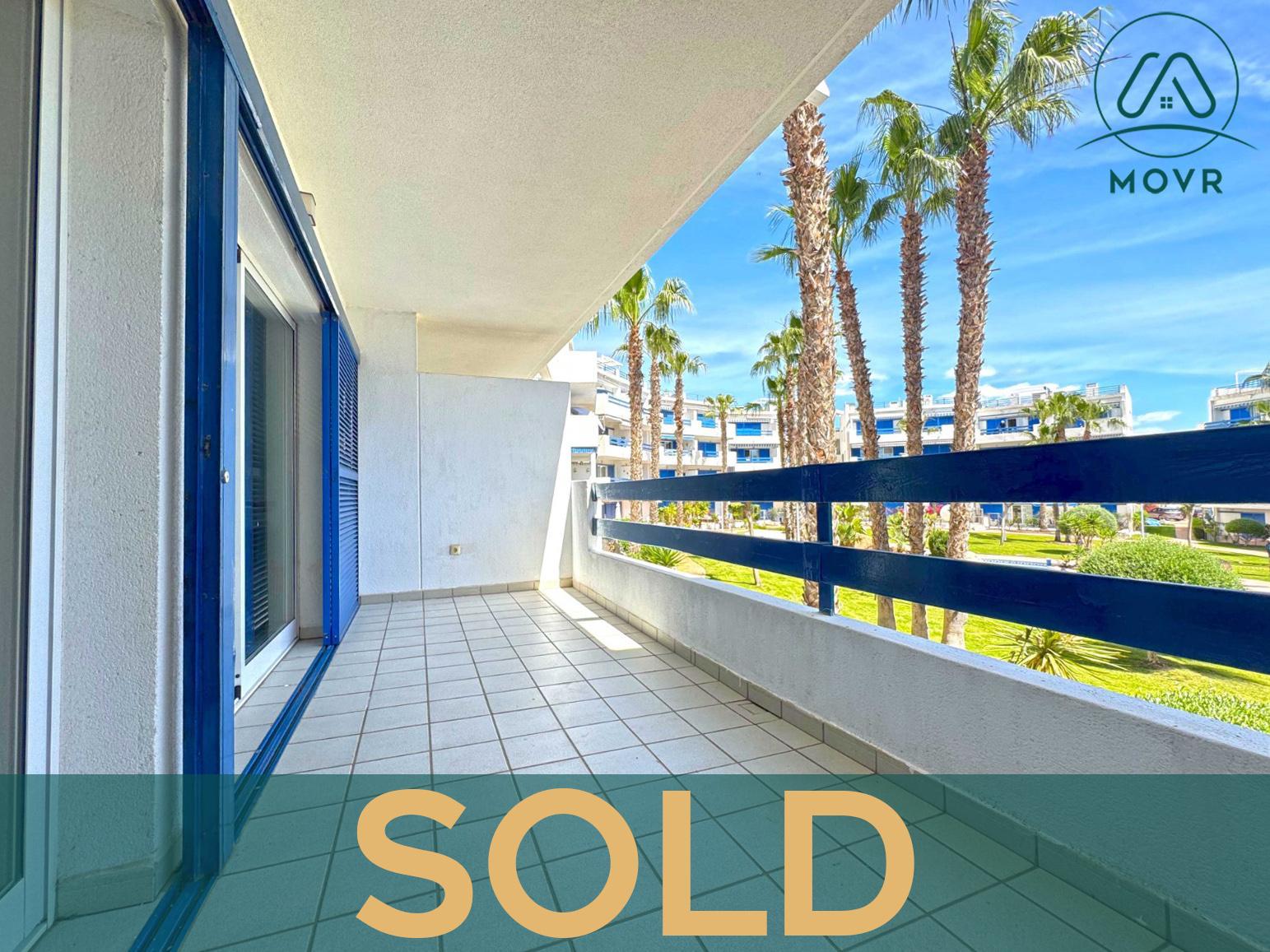 Apartment terrace overlooking palm-lined communal gardens previously sold by MOVR in Orihuela Costa