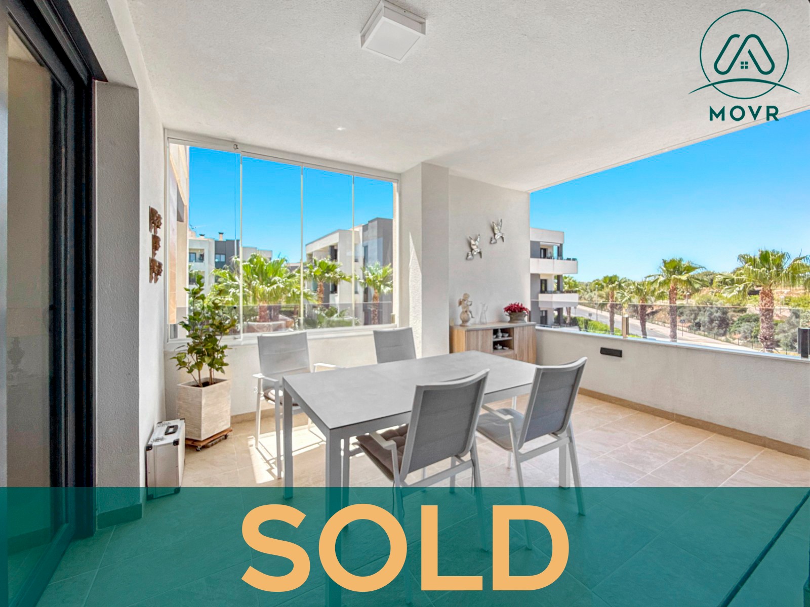 Covered apartment terrace with dining table and green valley views previously sold by MOVR in Orihuela Costa