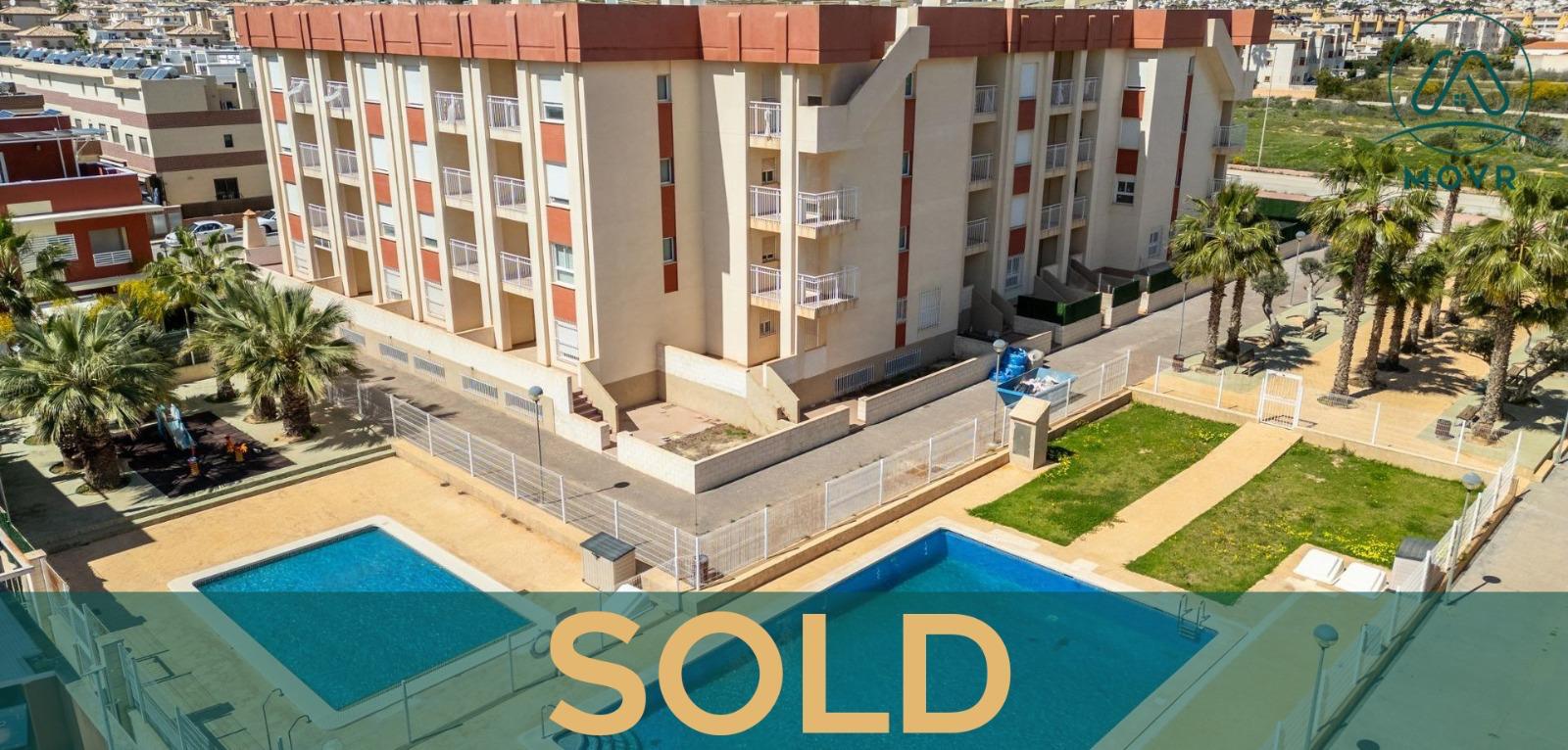 Apartment building with communal pools previously sold by MOVR in Orihuela Costa